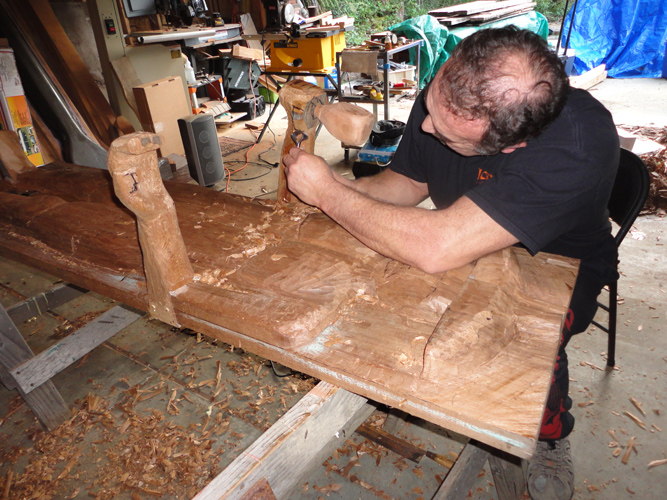 Image of Delbert carving wood